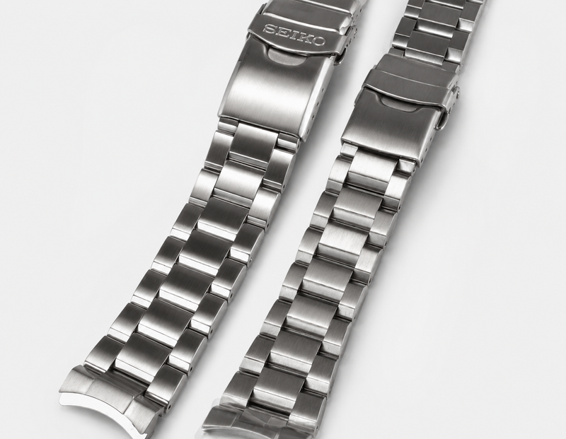 Steel bracelets showing the curved end link that closes the gap between the lugs